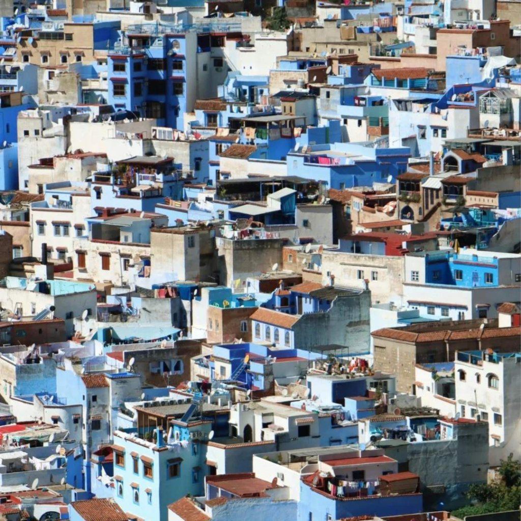 Iconic blue painted buildings of Chefchaouen Morocco cascading down mountainside in Rif Mountains