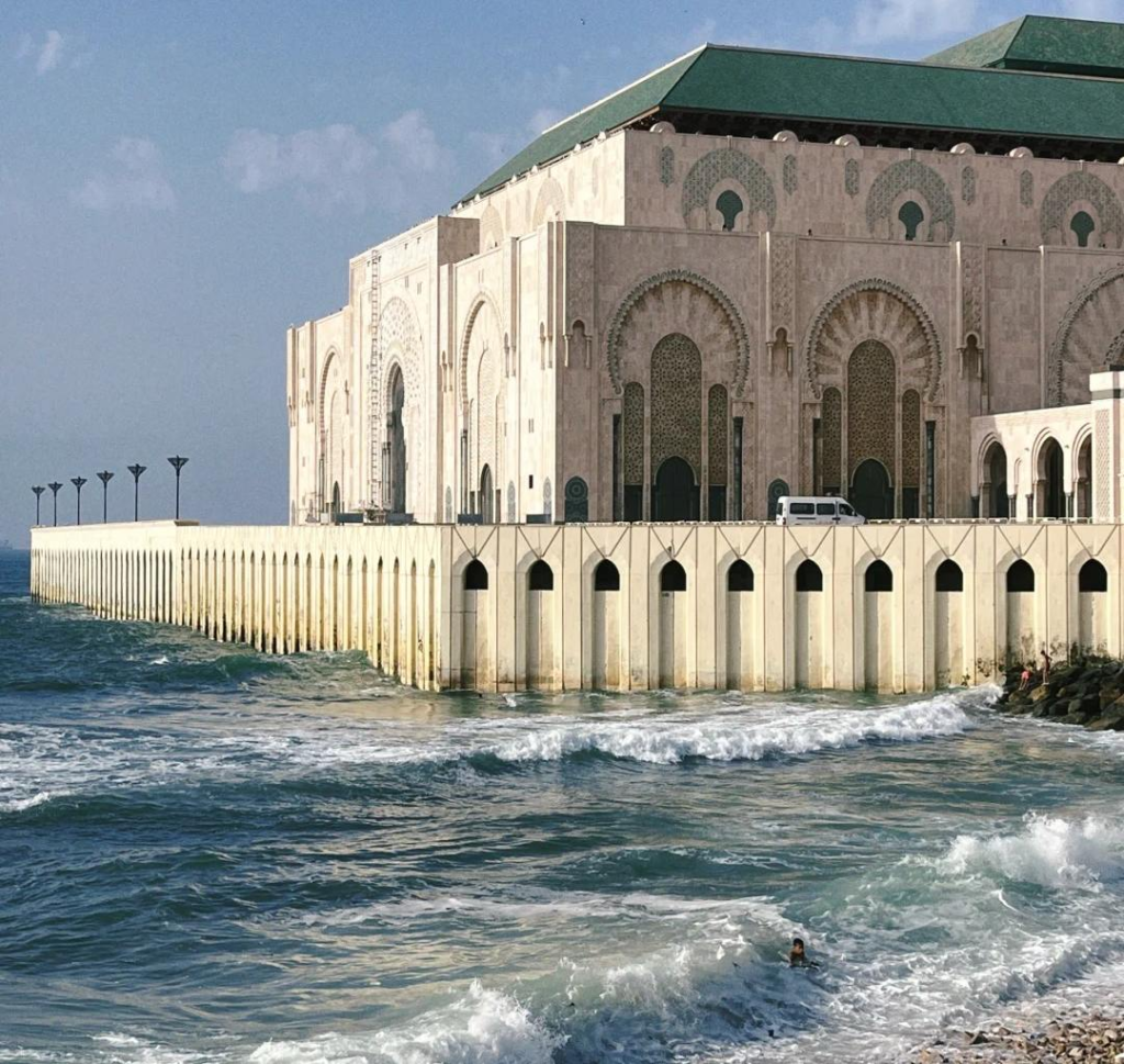 Hassan II Mosque in Casablanca built over Atlantic Ocean with traditional Islamic architecture and green roof