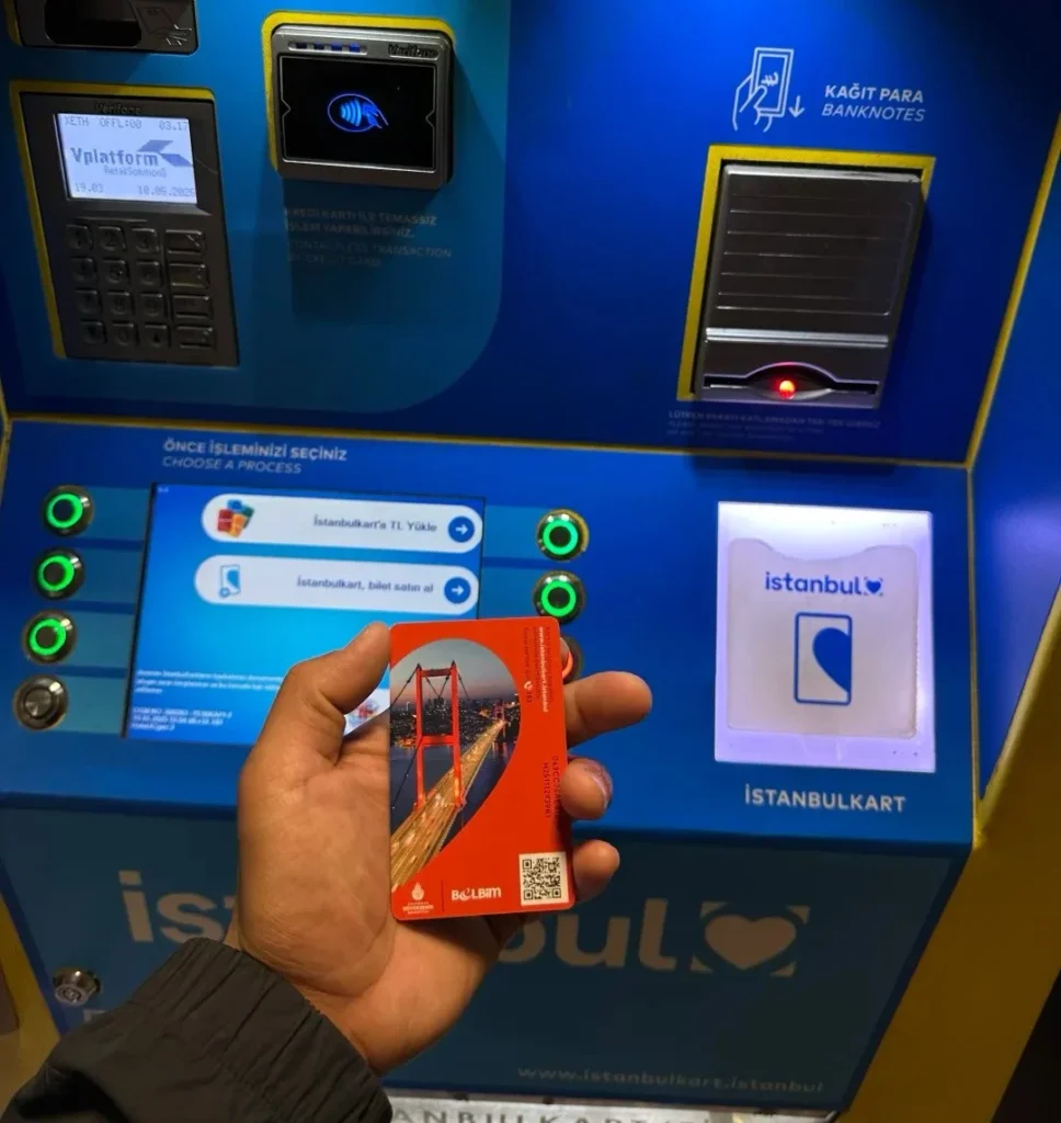 Hand holding Istanbul transport card at blue ticket vending machine