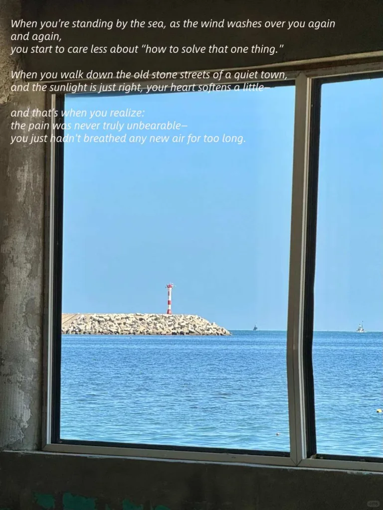 View of a lighthouse on a rocky breakwater from a window, symbolizing new perspectives and the calming effect of the sea.