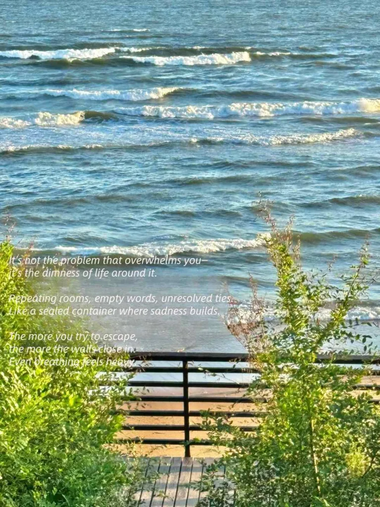 Ocean waves gently breaking on the shore viewed from above, with lush green foliage and a railing in the foreground, ideal for calming reflections.