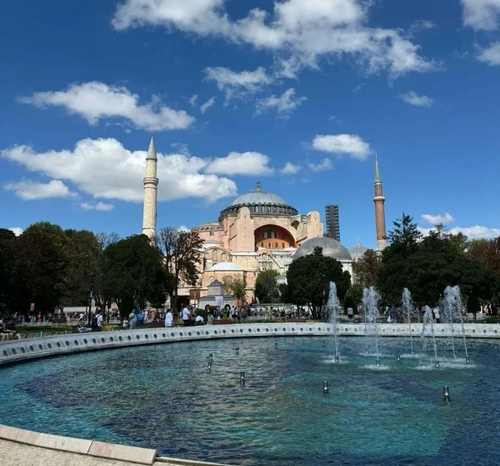 Historic Hagia Sophia mosque with fountain in foreground and tourists in Sultanahmet Square Istanbul