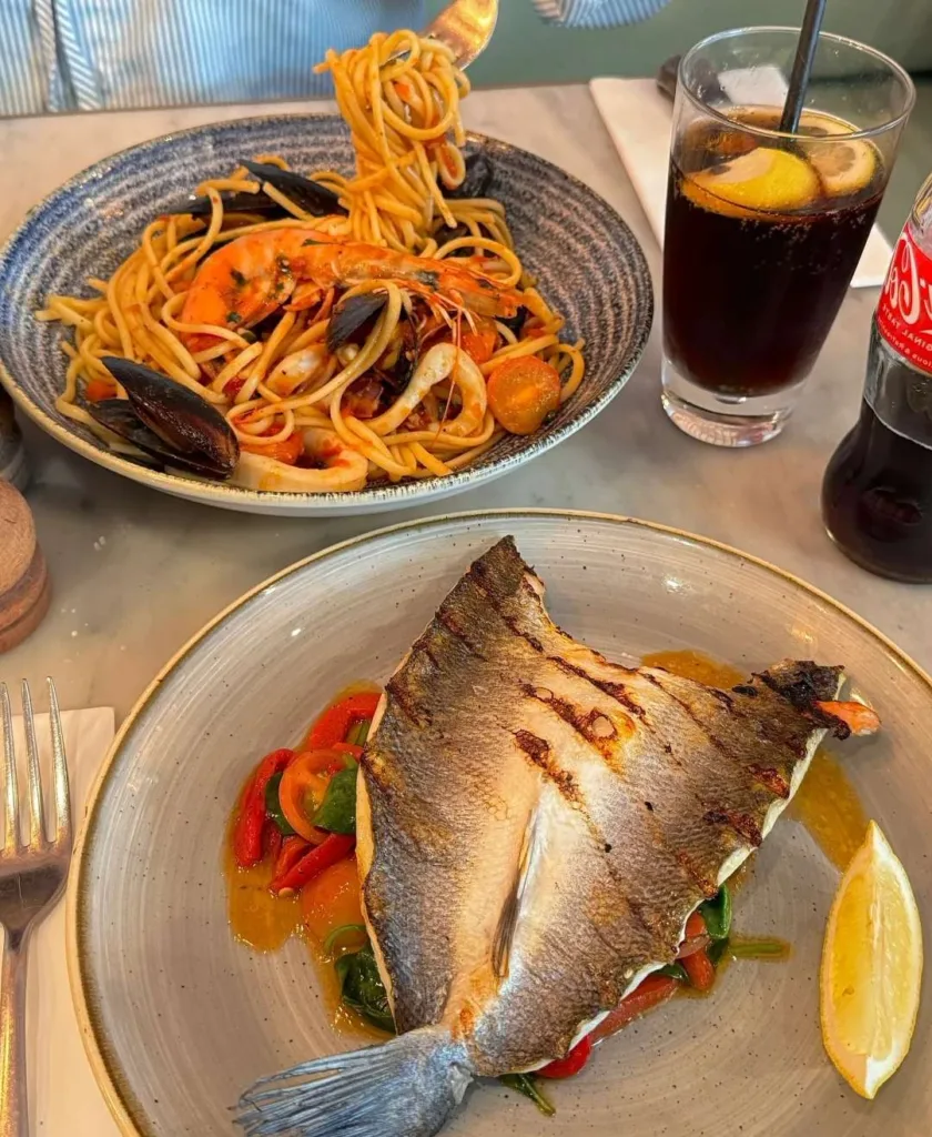 Delicious seafood pasta and grilled fish served at restaurant in Llandudno Welsh seaside town