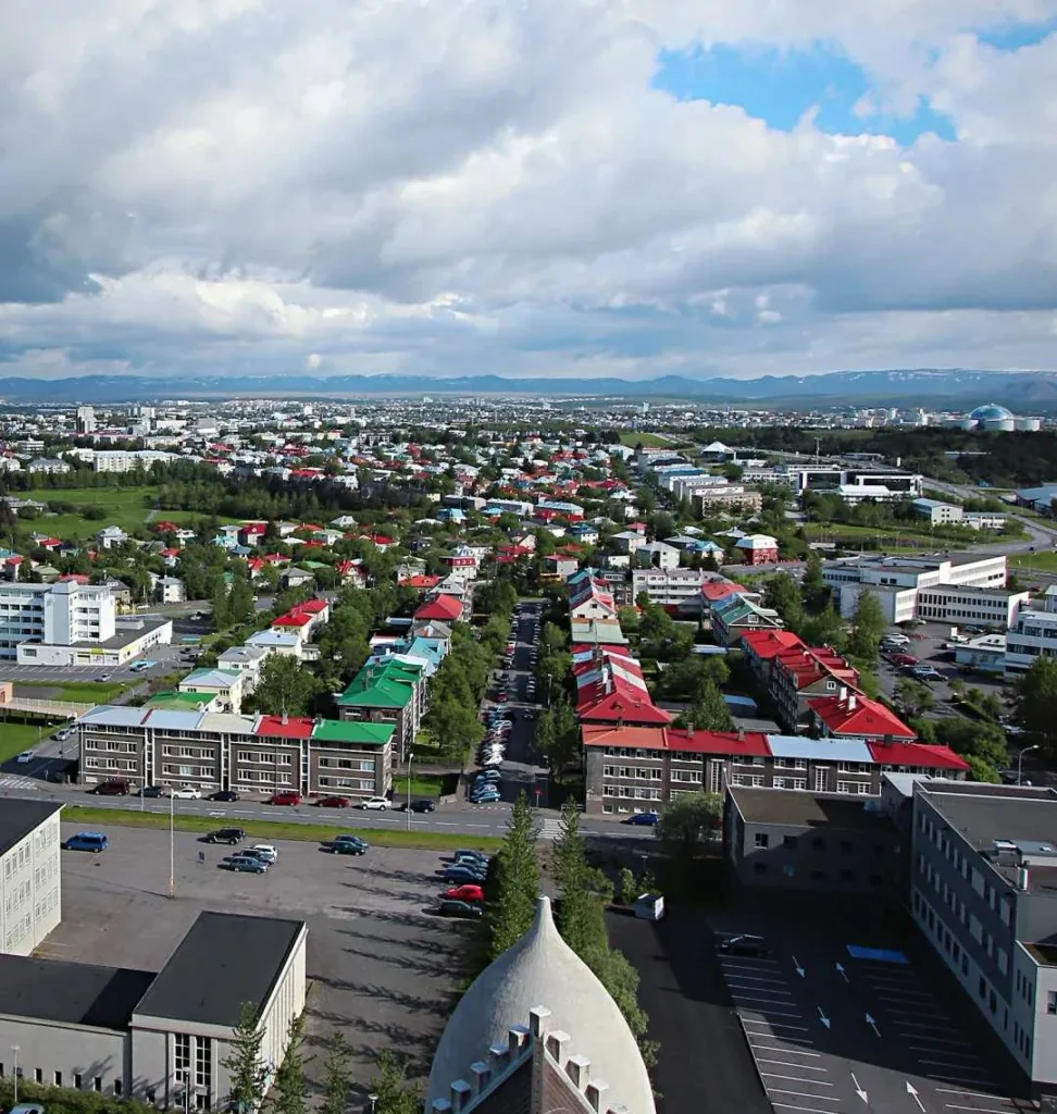 Aerial panoramic view of Reykjavik showing colorful rooftops, residential areas and mountains in background