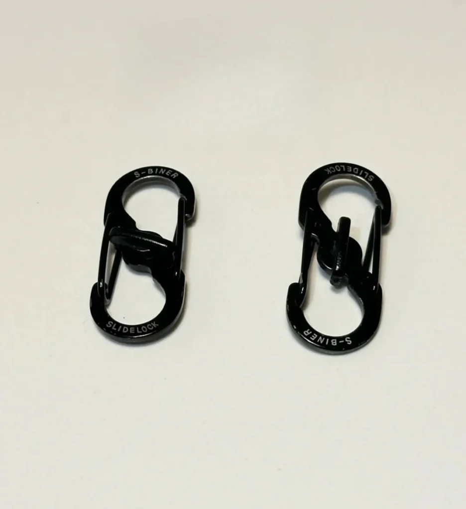 Two black S-biner carabiner clips with slidelock mechanism for secure zipper and bag protection