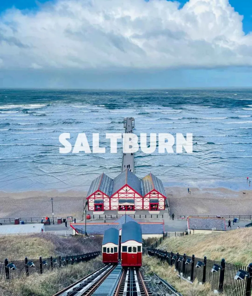 Victorian cliff tramway descending to beach at Saltburn-by-the-Sea with North Sea waves and pier in Yorkshire