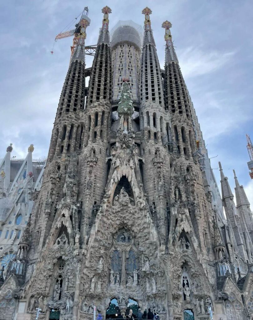 Antoni Gaudí's masterpiece Sagrada Familia showing intricate stone carved Nativity facade with towering spires under construction