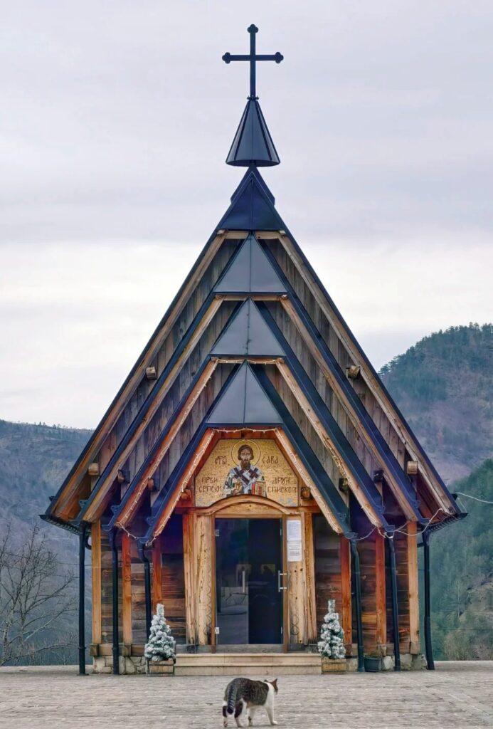 Beautiful wooden Orthodox church with ornate architecture and religious iconography in Drvengrad village created by director Emir Kusturica
