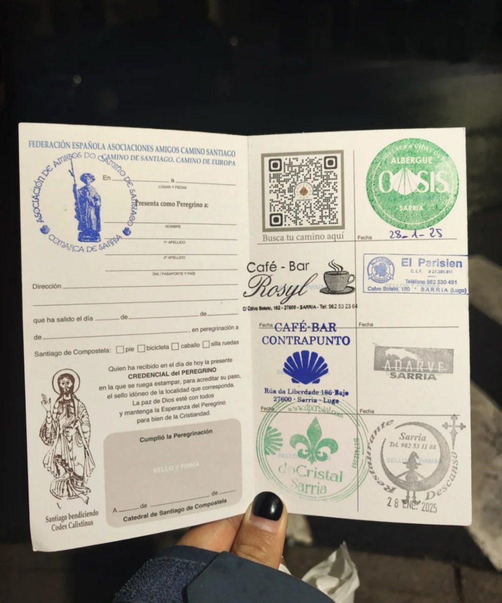 First Camino guide pilgrim passport showing authentic stamps from cafes, albergues, and official Camino locations