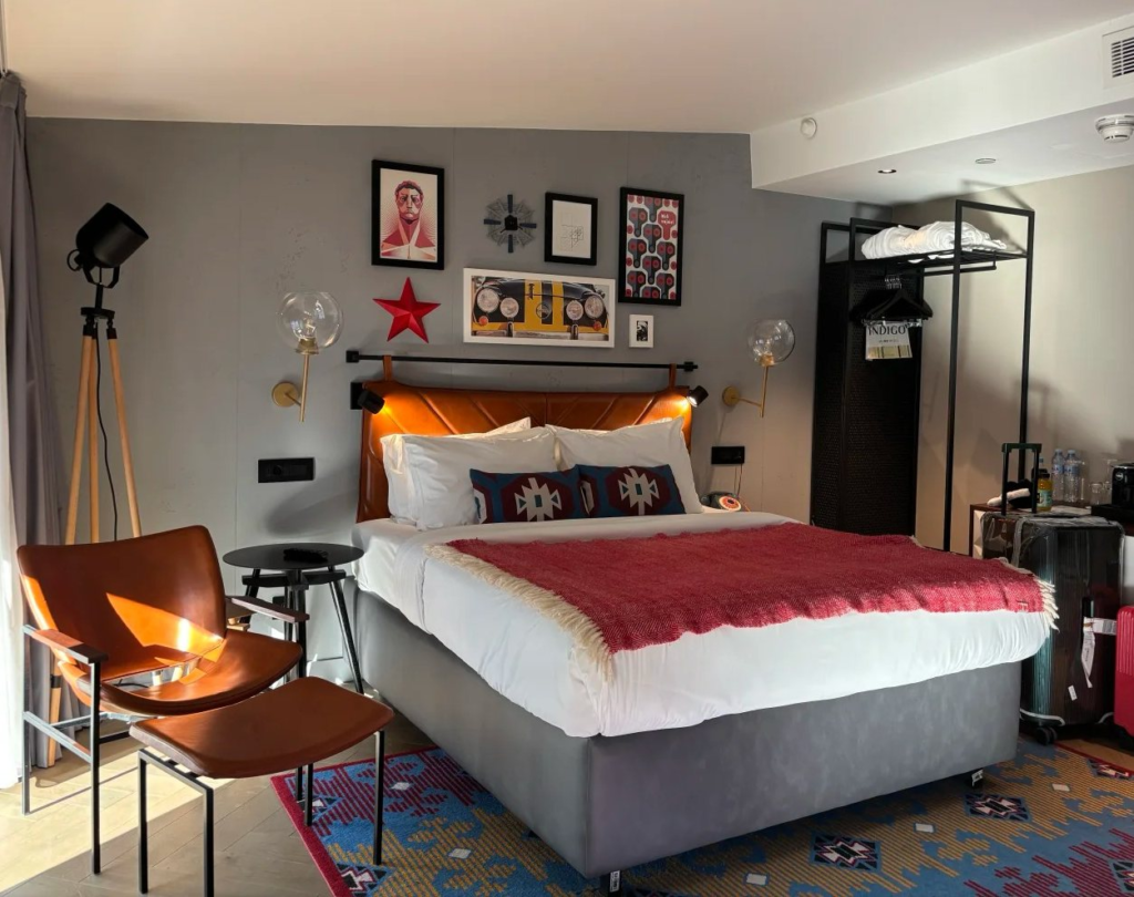 Stylish modern hotel room in Belgrade featuring contemporary design with traditional Serbian textile patterns, warm lighting and boutique amenities