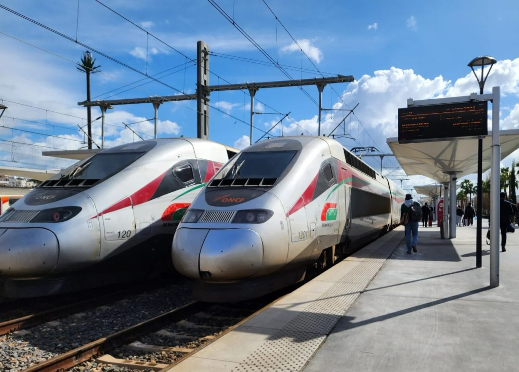 Modern white and red Al Boraq high-speed trains at clean ONCF railway platform with passengers boarding