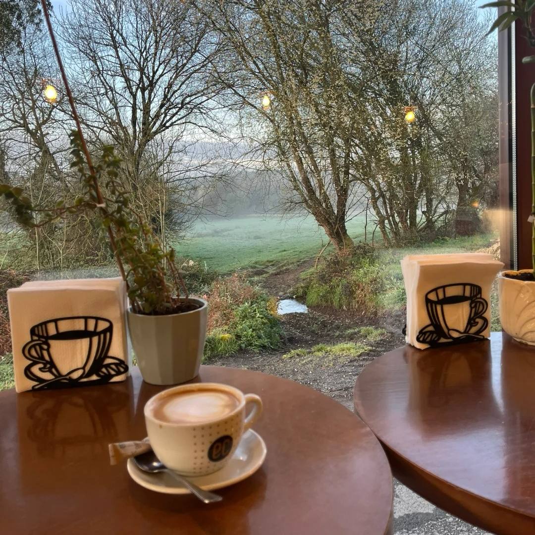 Cappuccino in cozy cafe with misty countryside view Santiago Ways