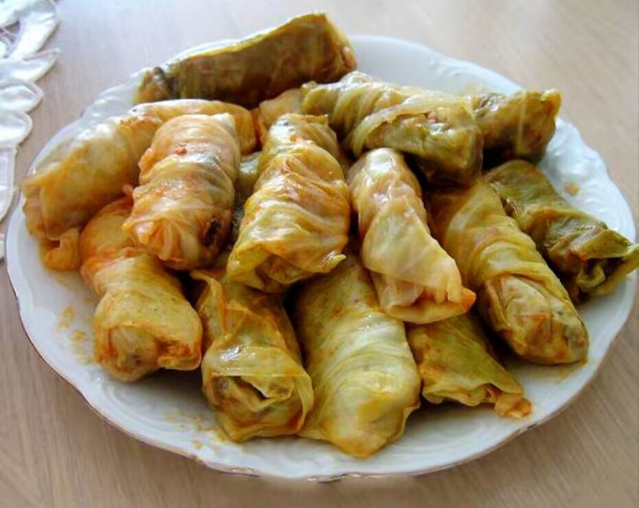 Plate of traditional Serbian sarma - stuffed cabbage rolls filled with ground meat and rice, classic Balkan comfort food