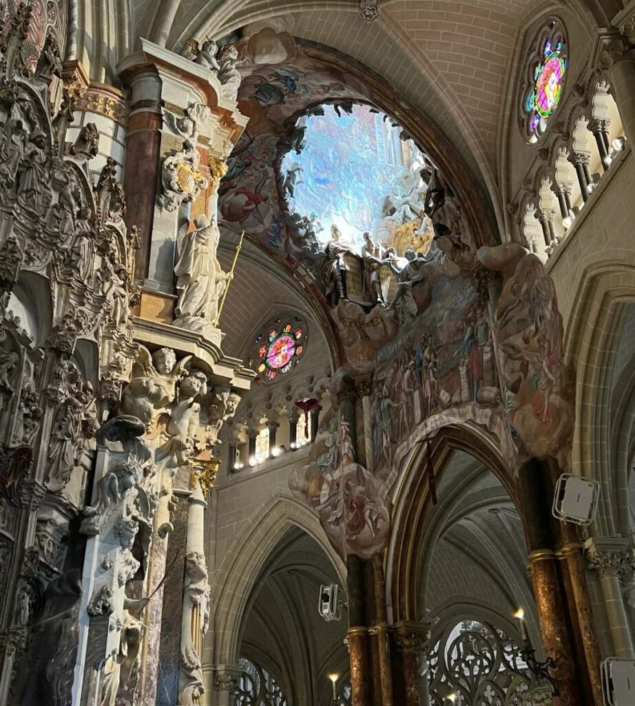 Breathtaking Toledo Cathedral interior showing Gothic vaulted ceilings, elaborate frescoes, and stunning architectural details