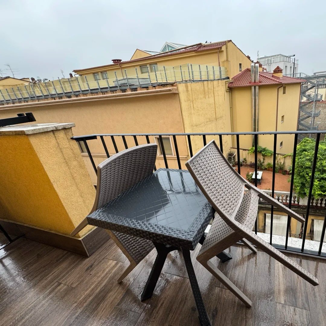 Europe travel hotel room balcony overlooking European city rooftops