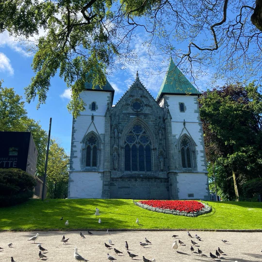 Norway drive destination Stavanger Cathedral featuring Gothic architecture with twin spires and seabirds in foreground