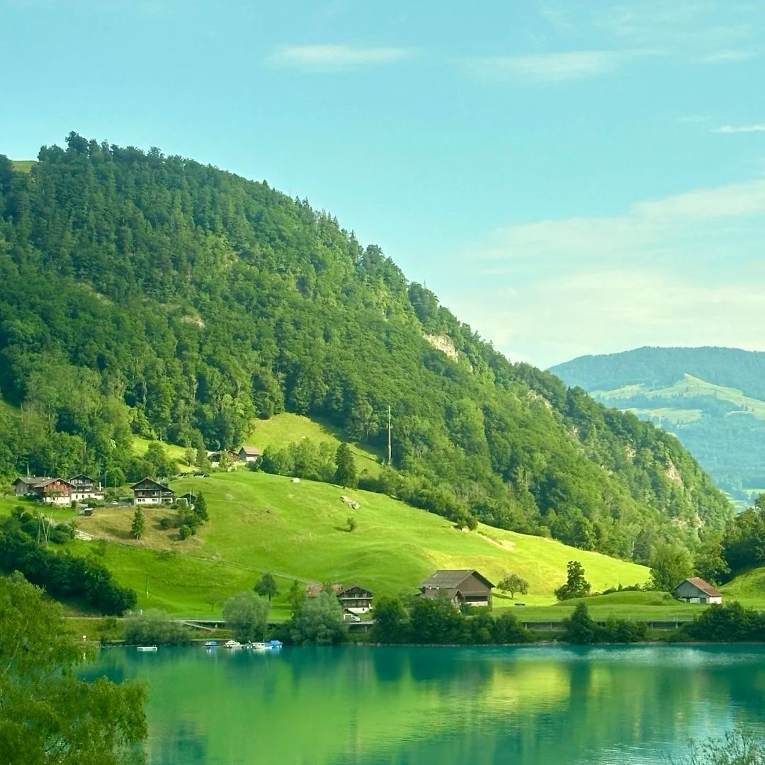 Swiss culture guide traditional alpine village by pristine lake