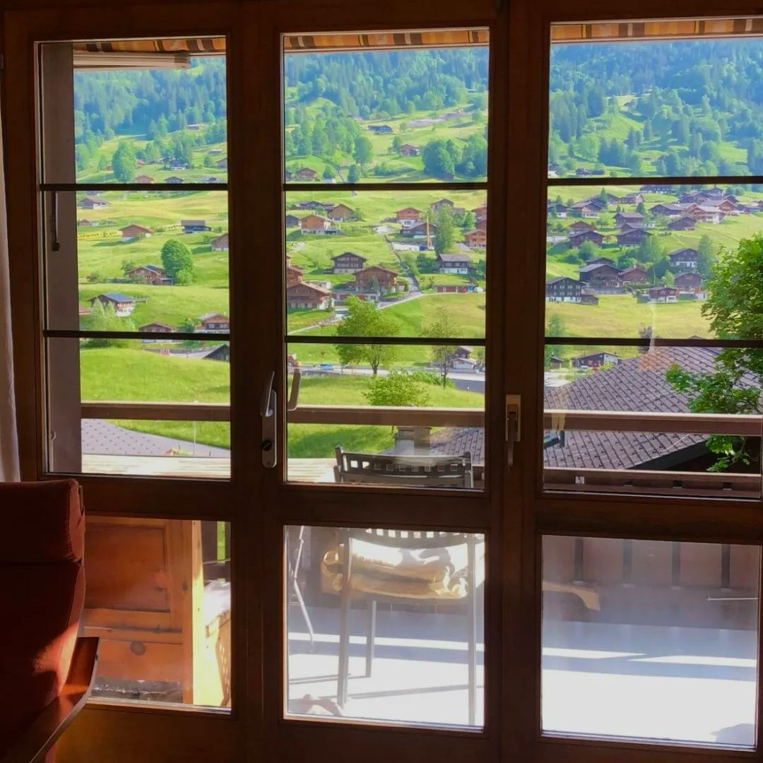 Switzerland accommodation guide room view overlooking alpine village