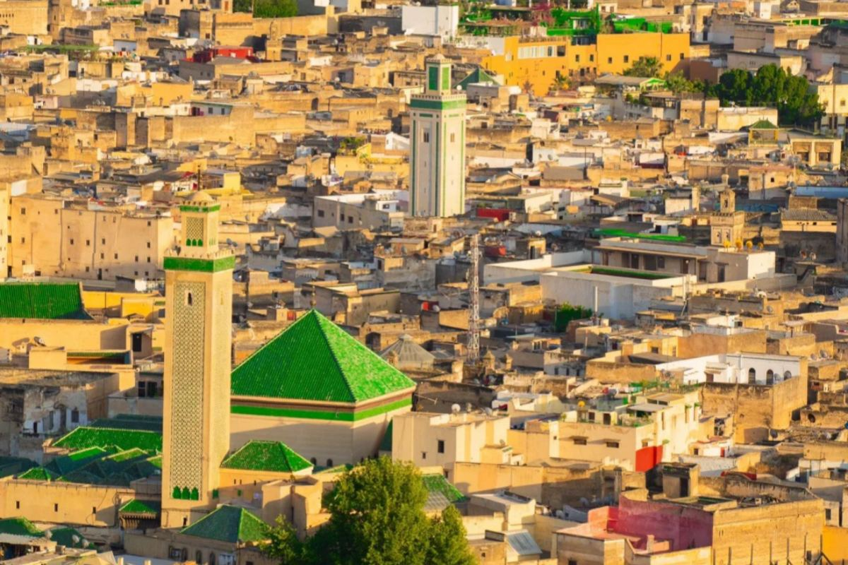 Famous Fez leather tannery with colorful dye vats viewed through traditional archway showing ancient craftsmanship