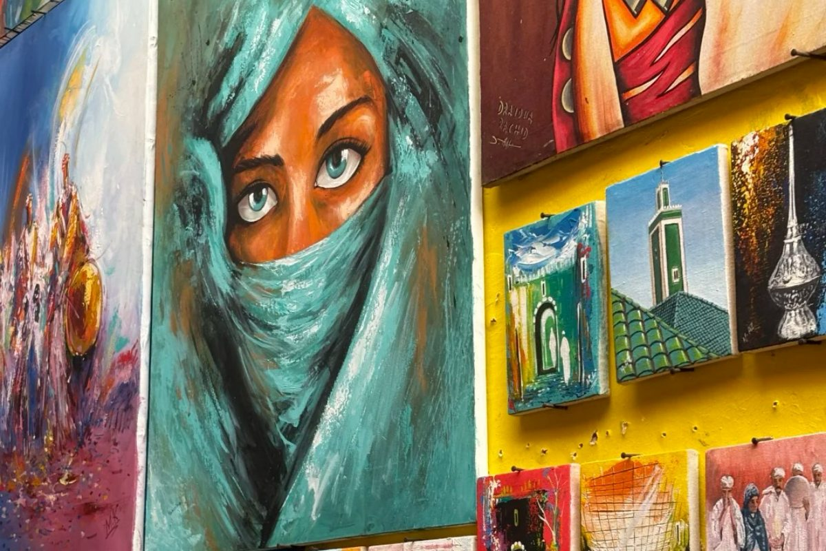 Colorful Moroccan artwork and paintings displayed in traditional riad showcasing local artistic culture