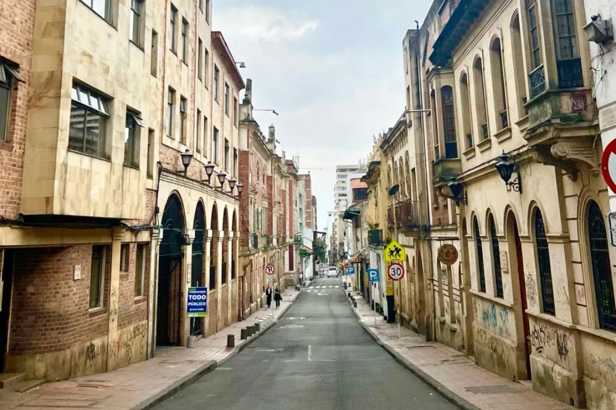 Historic colonial street with traditional Spanish architecture, balconies and arched buildings in Colombian city center