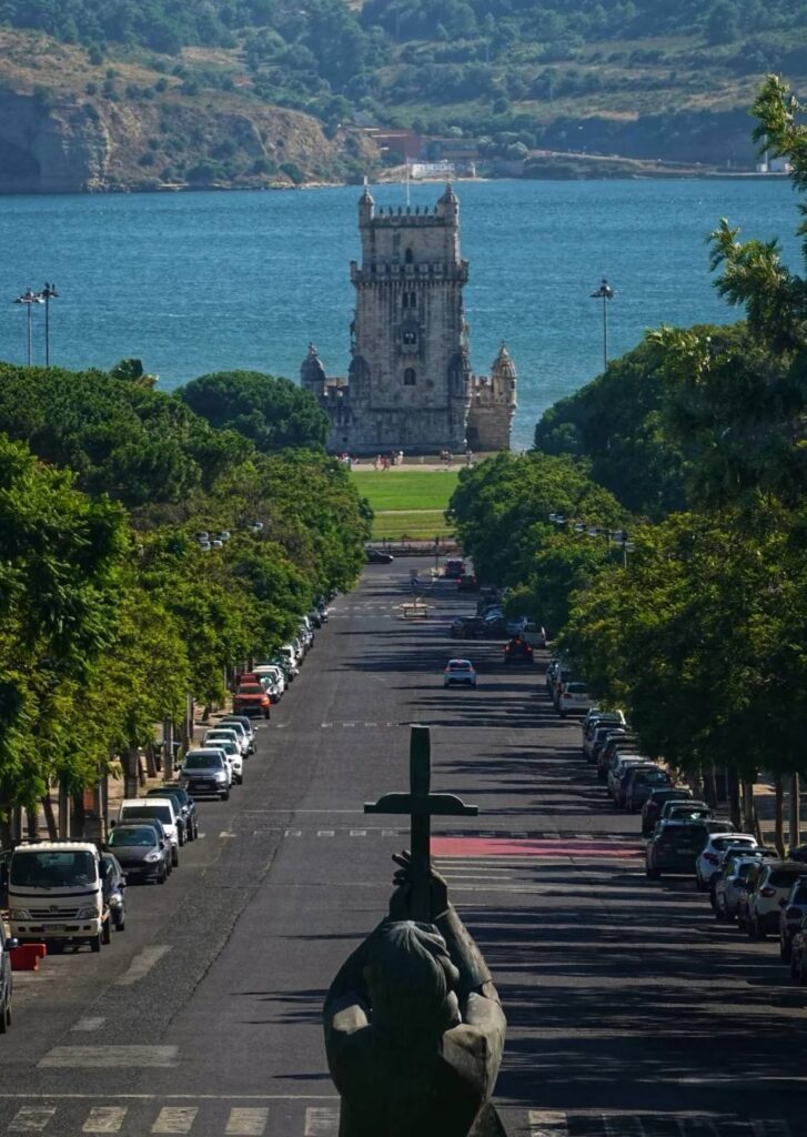 View of Belém Tower across the green boulevard, facing the Tagus River – Become A Traveller