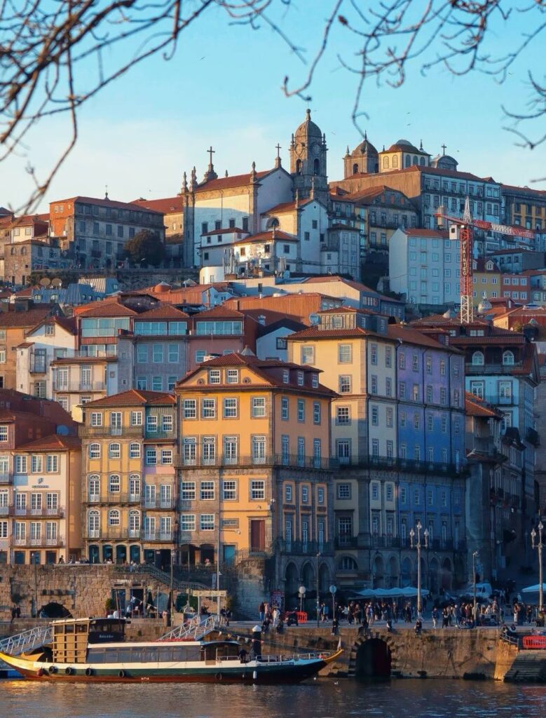 Sunset view of Ribeira’s colorful buildings by the Douro River in Porto – Become A Traveller