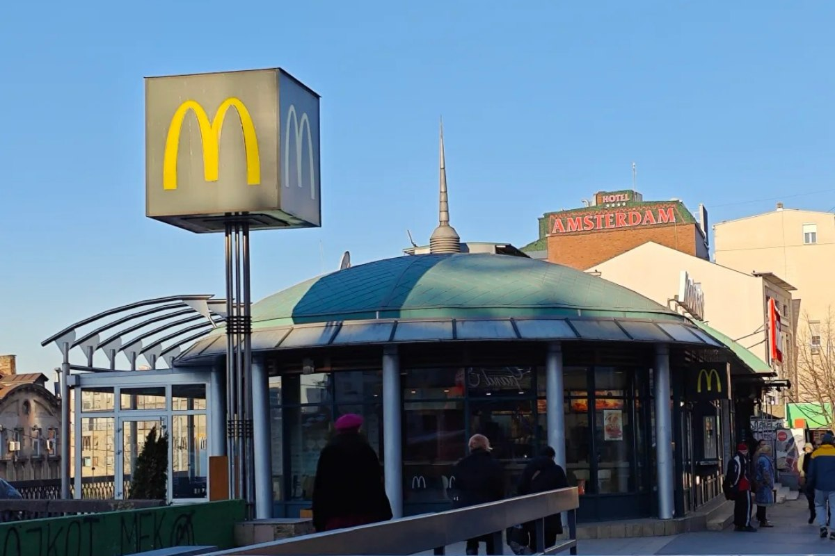 Street view of Hotel Amsterdam in Belgrade city center with McDonald's and urban infrastructure showing convenient location near amenities