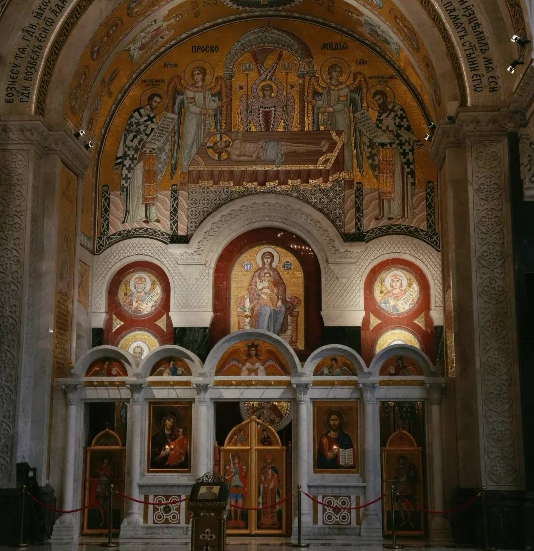 Ornate interior of Saint Sava Church showing golden Orthodox mosaics, iconostasis and religious artwork in Belgrade's largest church