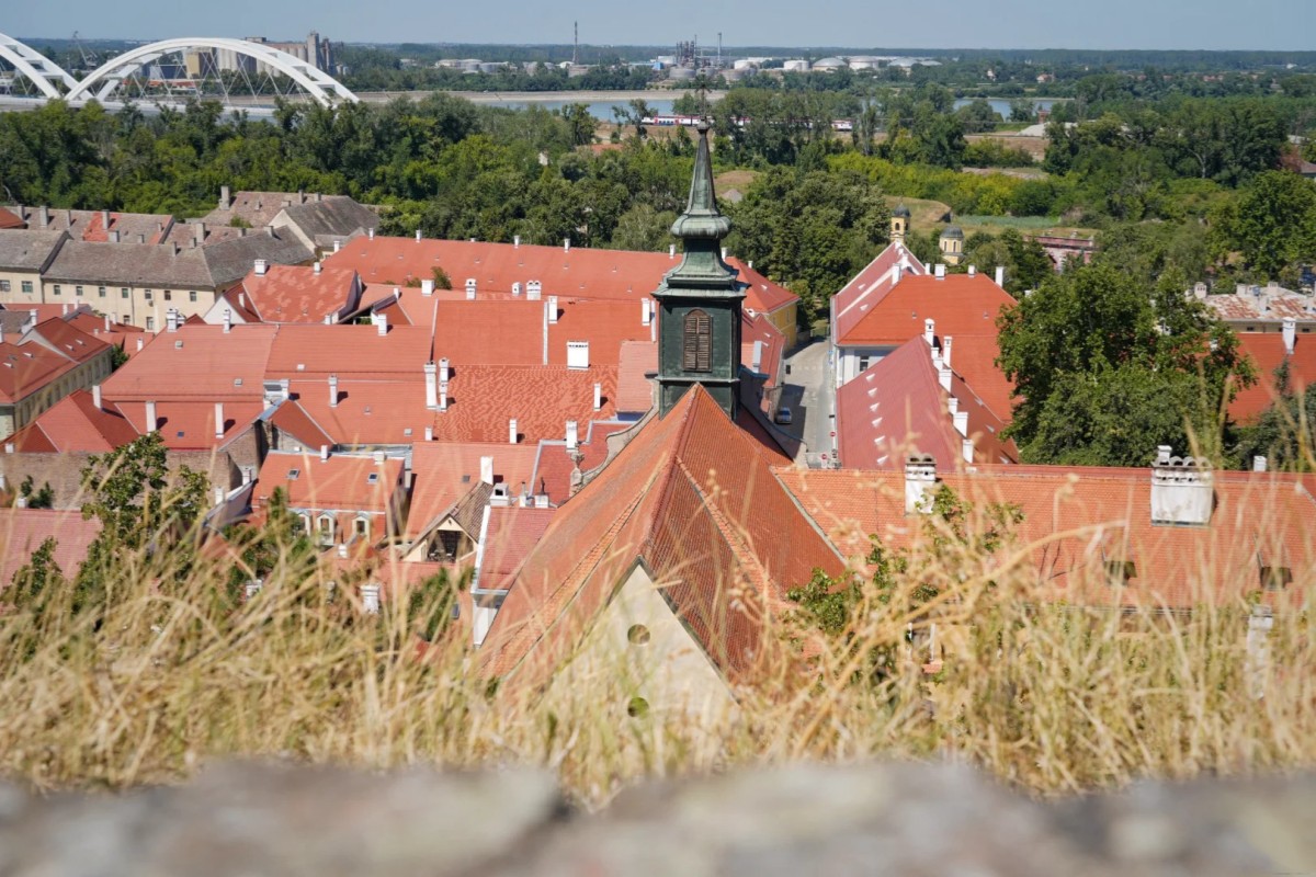 Panoramic view of Zemun district rooftops with traditional red tiles and church tower overlooking Danube River area in Belgrade