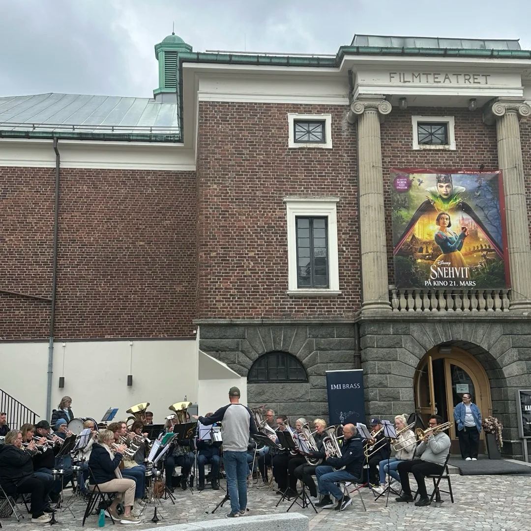 Norway drive urban culture in Stavanger showing local brass band performance outside historic Filmteatret cinema