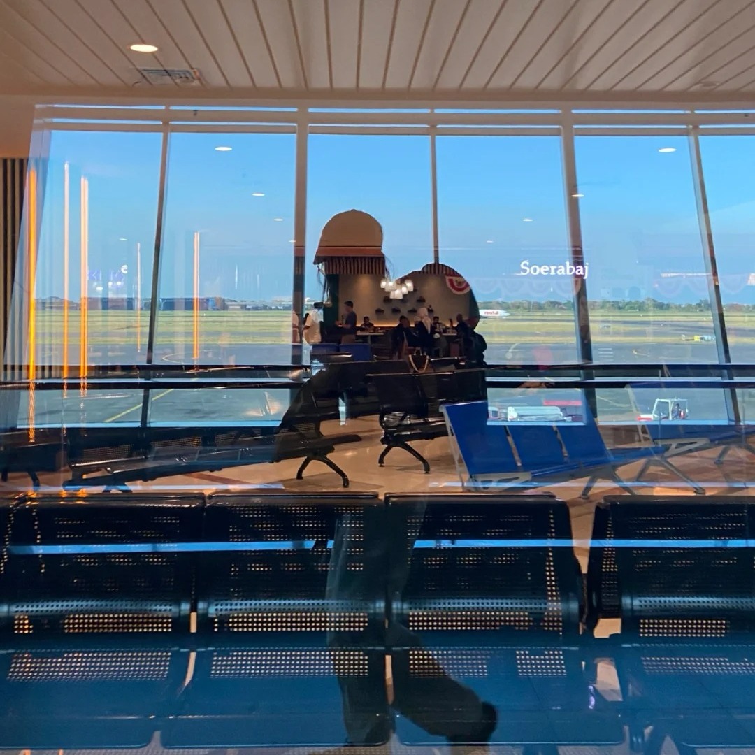 Solo female travel woman waiting at airport terminal