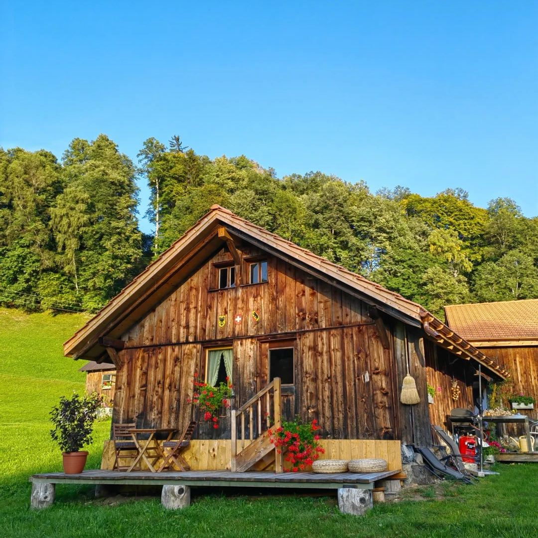 Switzerland accommodation guide traditional wooden chalet with flowers